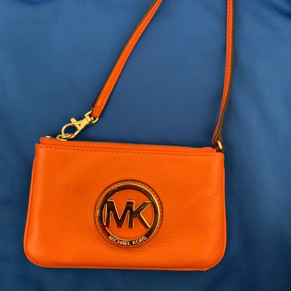 MICHAEL KORS bright orange wristlet.